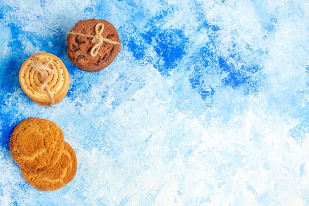 Top view cookies tied up with rope on blue table