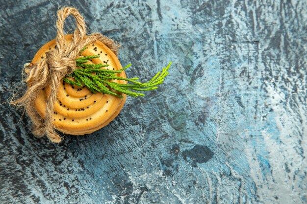 Top view cookies tied with a rope on grey surface copy space