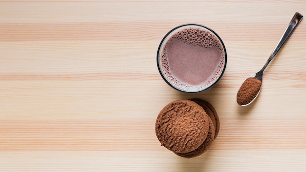 Top view cookies with chocolate milk and copy space