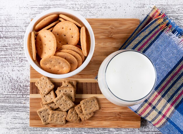 Free photo top view cookies with milk on wooden board on white wooden  horizontal