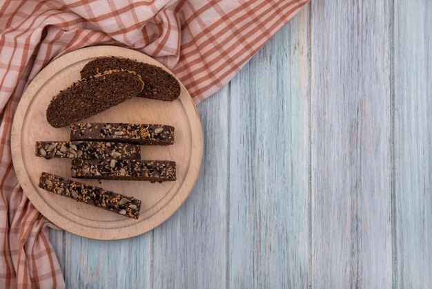 Top view  copy space brown bread slices on stand  on gray background