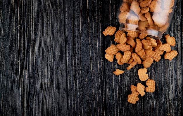 Top view copy space cookies in a jar on a black wooden background