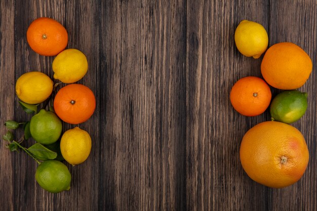Top view  copy space grapefruit with oranges  lemons and limes on wooden background