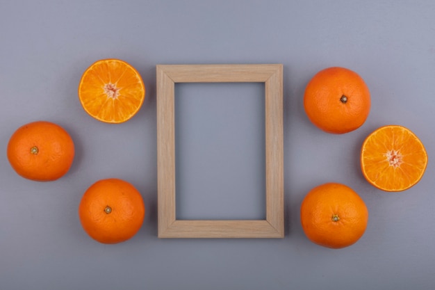 Top view  copy space oranges with beige frame on gray background