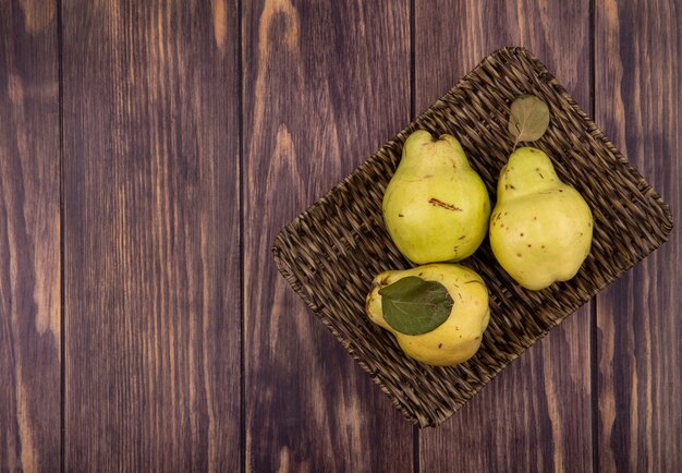 Top view copy space pears in basket on wooden wall