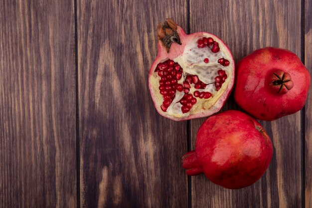 Top view copy space pomegranates on wooden wall