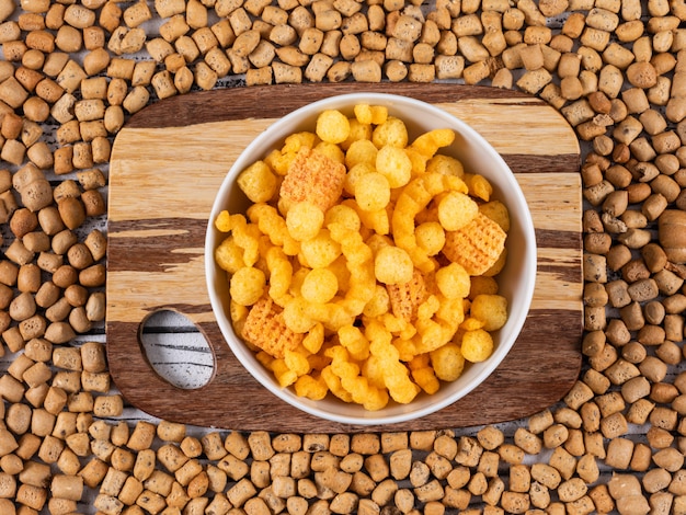 Top view of corn balls on cutting board and on crackers texture horizontal