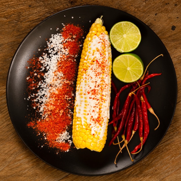 Top view of corn on plate with limes