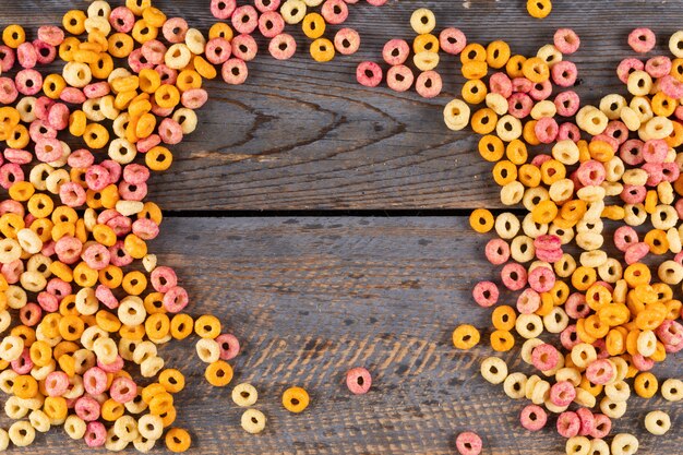 Top view of corn rings with copy space in the middle on dark wooden  horizontal