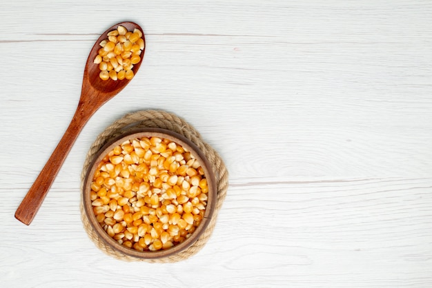 Top view corn seeds yellow colored on white