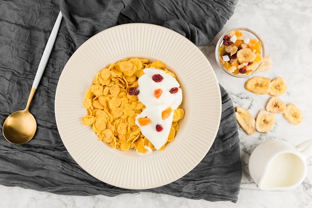 Top view cornflakes with yogurt and dried fruits