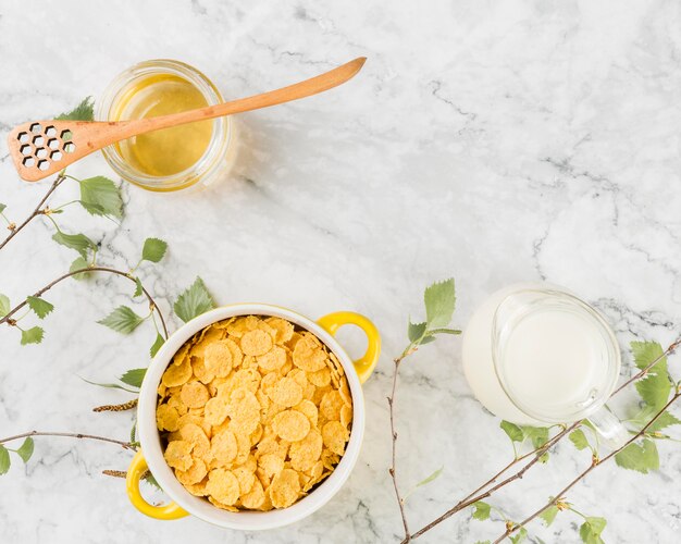 Top view cornflakes with yougurt and honey