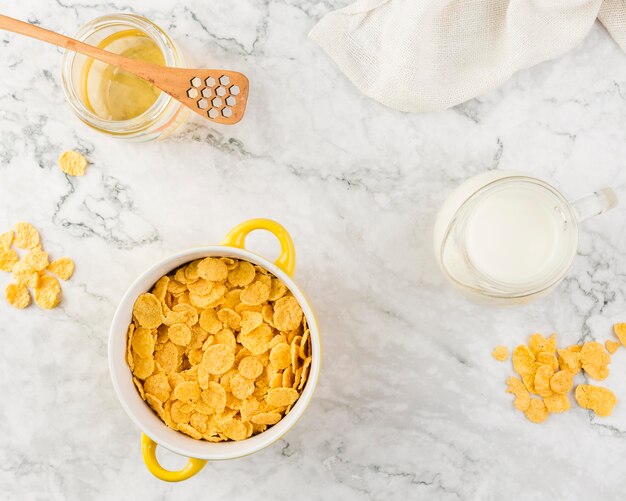 Top view cornflakes with yougurt and honey