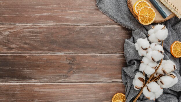 Top view cotton and dried oranges with copy-space