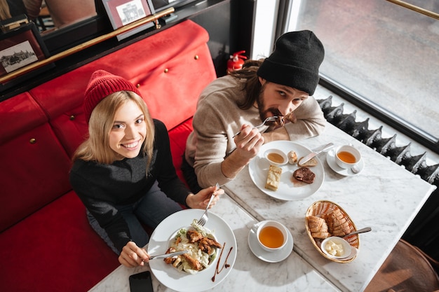 Top view of couple eating in cafe