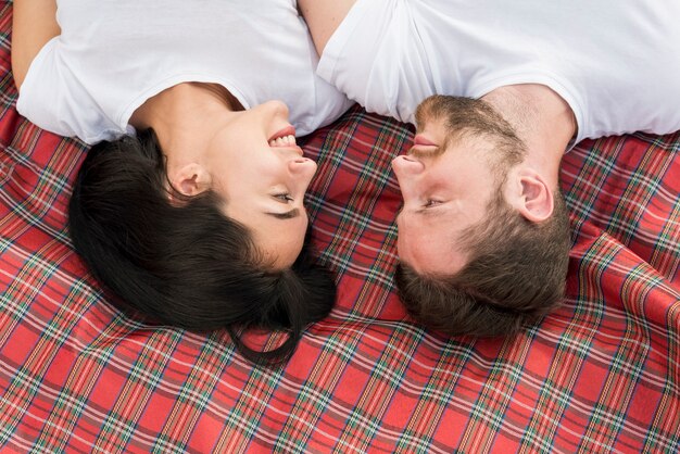 Top view couple laying on picnic blanket