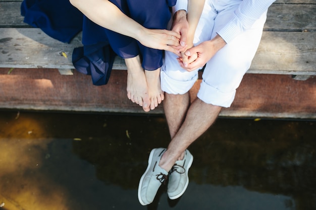 Top view of couple in love sitting on the lake