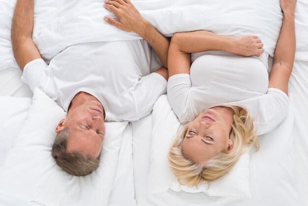 Top view couple sitting in bed