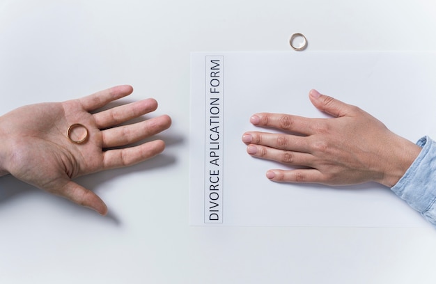 Free photo top view couple taking wedding rings off