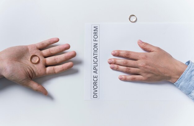 Top view couple taking wedding rings off