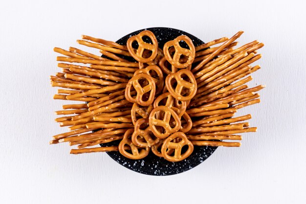 Top view crackers in black bowl on white  horizontal