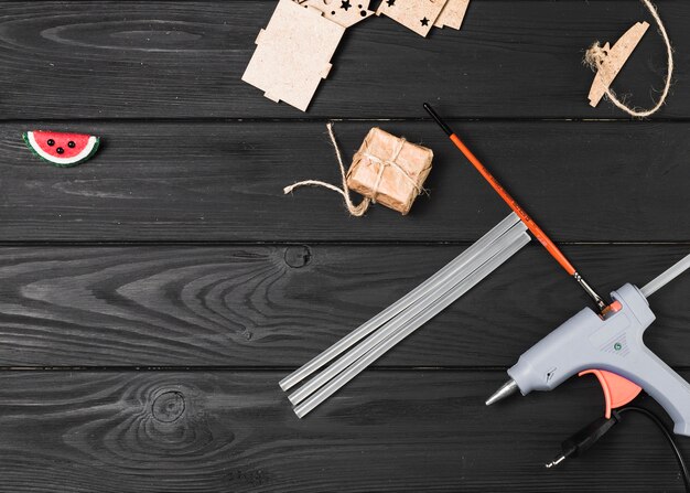 Top view of craft equipment on wooden backdrop