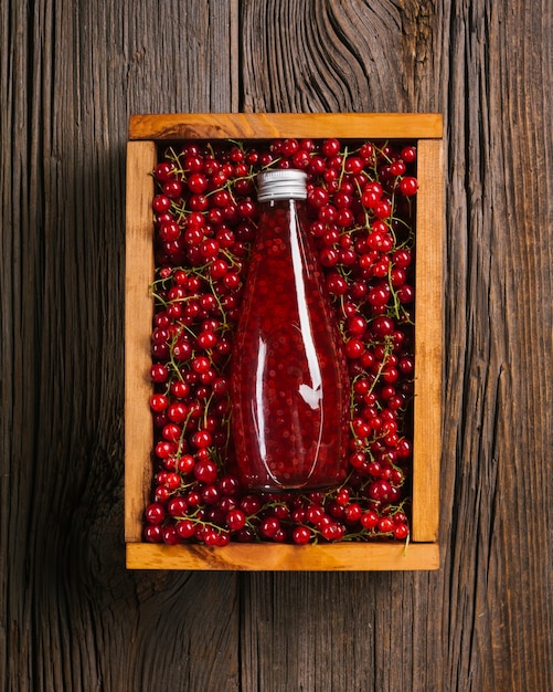 Top view cranberry juice on wooden background