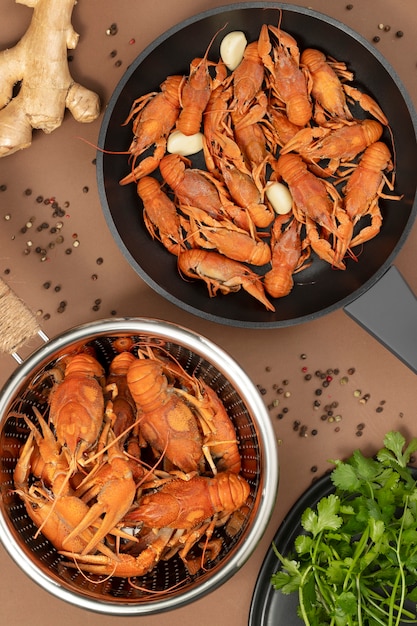 Free photo top view of crawfish in saucepan and colander