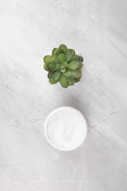 Top view of cream on marble background