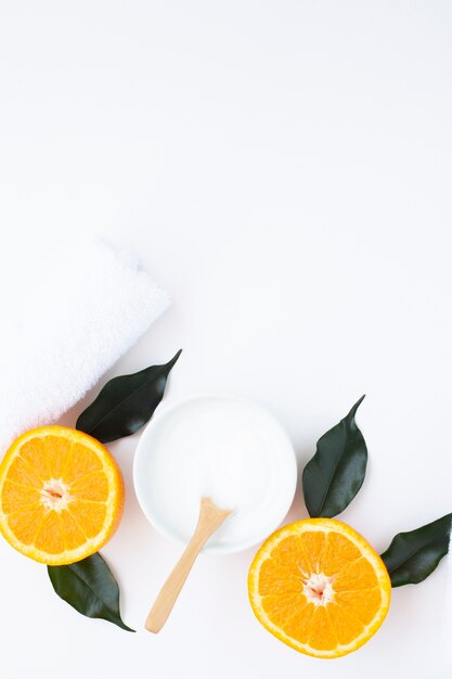 Top view of cream and orange on white background with copy space