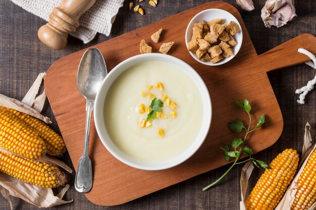 Top view cream soup bowl on wooden board