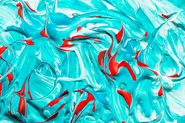 Top view of creative blue and red colored paint on surface