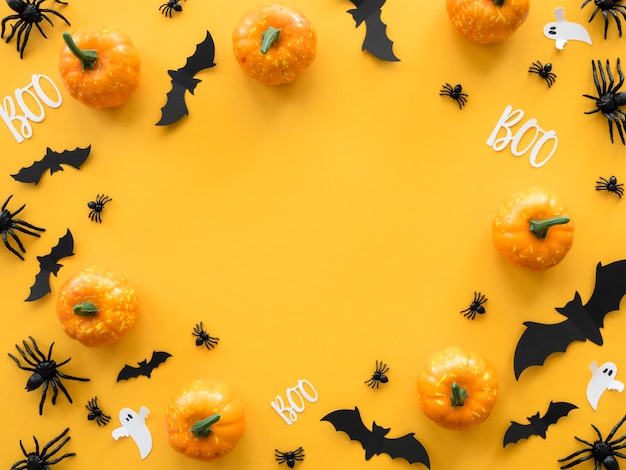 Top view creepy halloween concept with bats and pumpkins