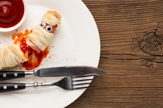 Top view creepy halloween food with cutlery