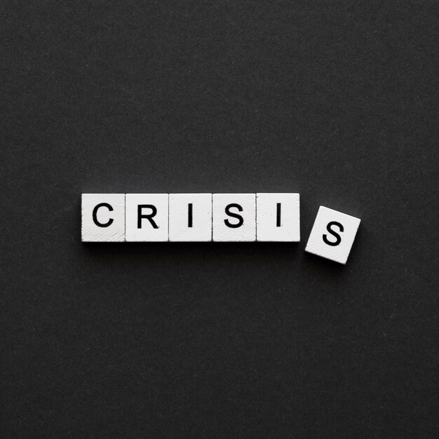 top view crisis word written on wooden cubes
