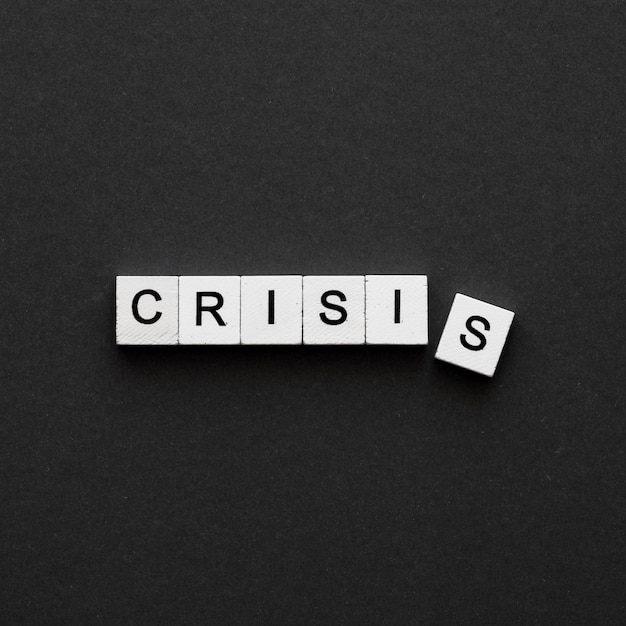 Top view crisis word written on wooden cubes