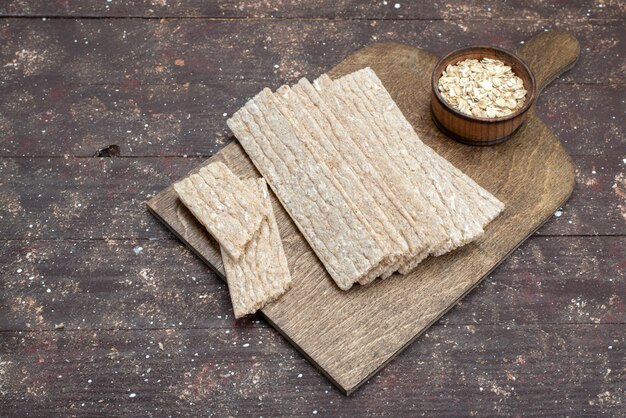 Top view crisps and crackers long formed on wooden desk