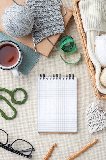 Top view of crochet set with yarn and notebook