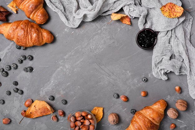 Top view of croissants, jam and chestnuts