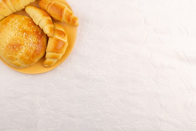 top view croissants and pastries yummy on the white background