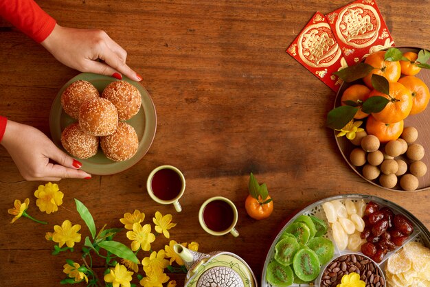 Top view of cropped female hands serving dishes preparing for New Year celebration