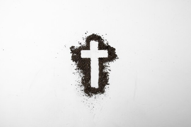 Вид сверху формы креста с темной почвой на белом