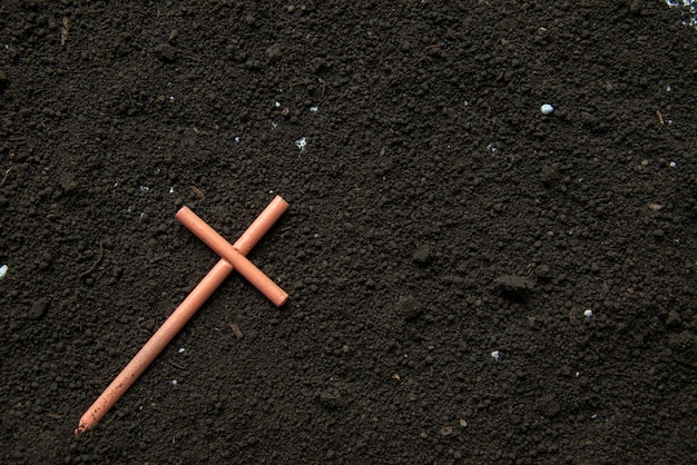 Top view of cross on soil grim reaper funeral devil death