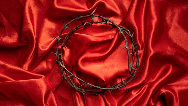 Top view crown of thorns on red cloth