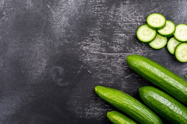 Top view cucumber sliced with copy space on black stone  horizontal 1