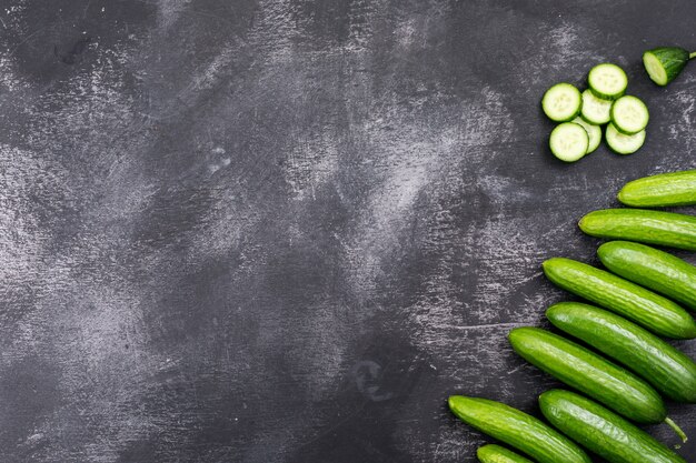 Top view cucumber sliced with copy space on black stone  horizontal