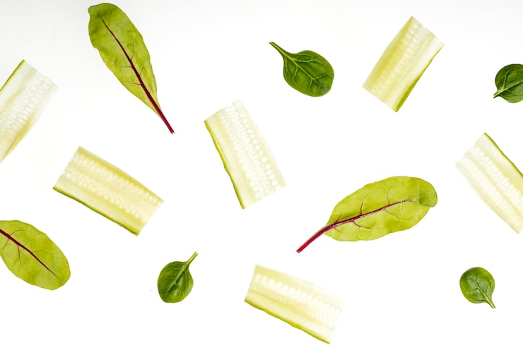 Free Photo top view cucumber slices and spinach