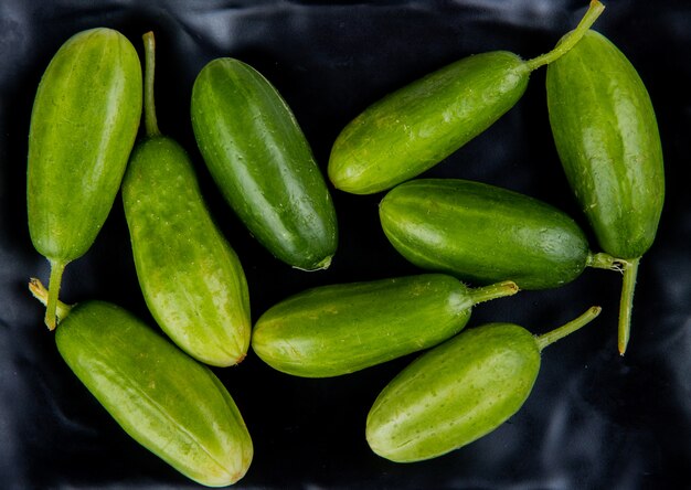 Top view of cucumbers on black surface