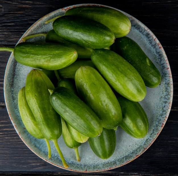 Top view of cucumbers in plate on wooden surface