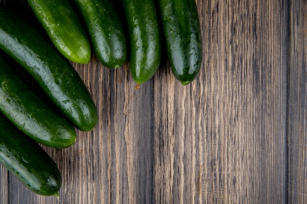 Top view of cucumbers on wooden surface with copy space